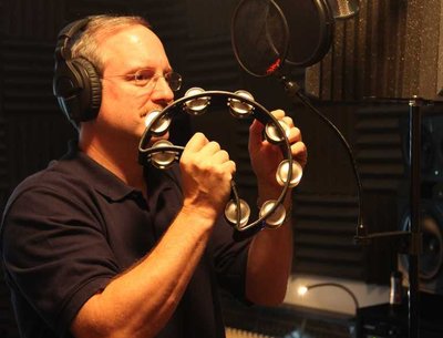 Warren playing a tamborine part on the new album.