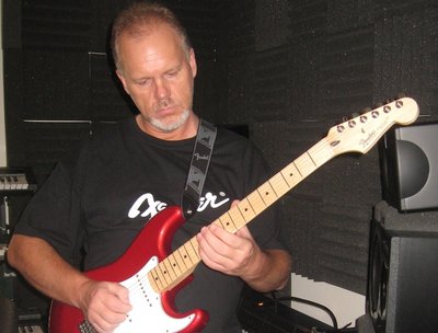 Mike in the studio, playing guitar.