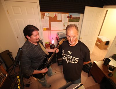 Jonathan showing Mike a new song in the studio.