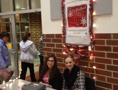 Marissa & Sarah working the sales table at a concert.