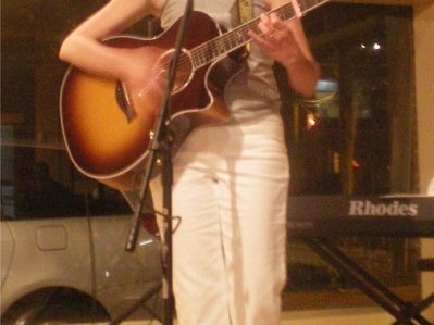 Kim playing guitar at Frederick Cellars 6/09