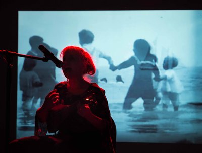 Alzara at SOMarts Gallery during multi-media performance. Photo by The Antic Staatsoper. 