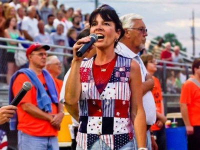 Cheryl singing National Anthem at Raiders Football game