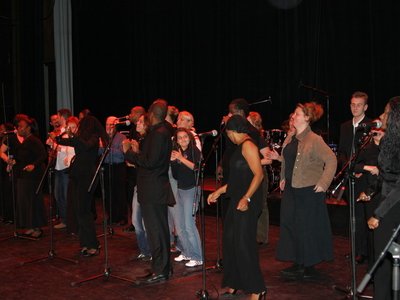 Some of the audience on stage with the group having a good, good, good, good tim