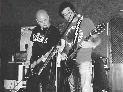 The drummer is playing the bass, the bass player is playing the guitar...