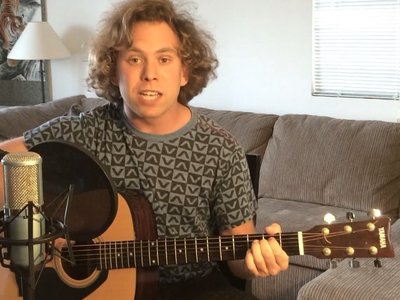 Alex on acoustic guitar while filming Moonlit Streets acoustic