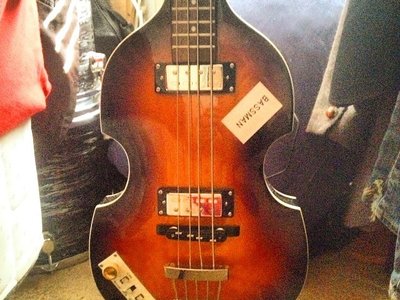 Later years HÃ¶fner bass with "Bassman" sticker as seen on the bass during the rooftop concert.
