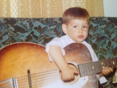 Scott at age 3 learning the guitar from dad.
