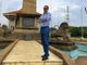 Mohamed Dekkak Chairman and Founder of Adgeco Group standing near the Statue of the Don Stephen 