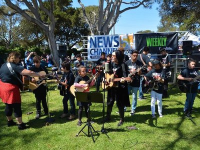 with Guitars Not Guns Goddess, Amy Warren; performing at the Monterey Blues Festival
