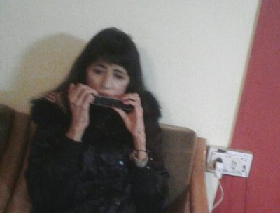 Playing the Harmonika in a little hut in the Indian hill clusters of Kasol in Himachal Pradesh..