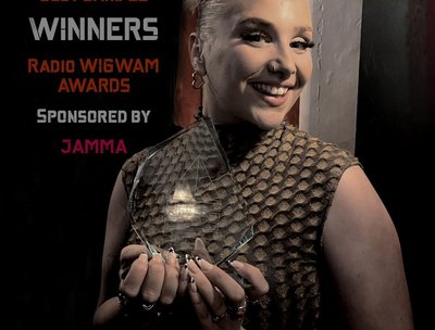 Lead singer of indifferentmonkey, Pippa, holding the trophy in London for "Winners" of Best Band 22.
