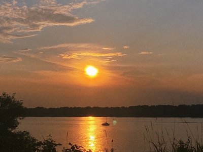 A golden sunset calms the water