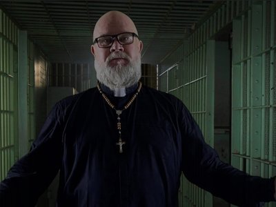 Screen snap of my older priest role in the music video for 'Terrible Tale.' 