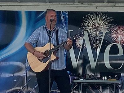 Adam from NT1078 performing a small acoustic set, June 2024
