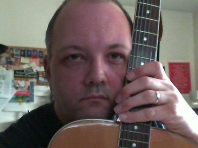 Vince at home with his acoustic guitar
