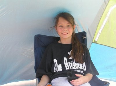 Emmalee daughter of Johnny harp  player of Brethren in sun tent at Helena